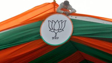 Worker tying BJP symbol for an election rally