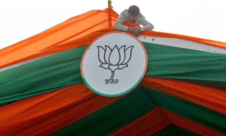 Worker tying BJP symbol for an election rally